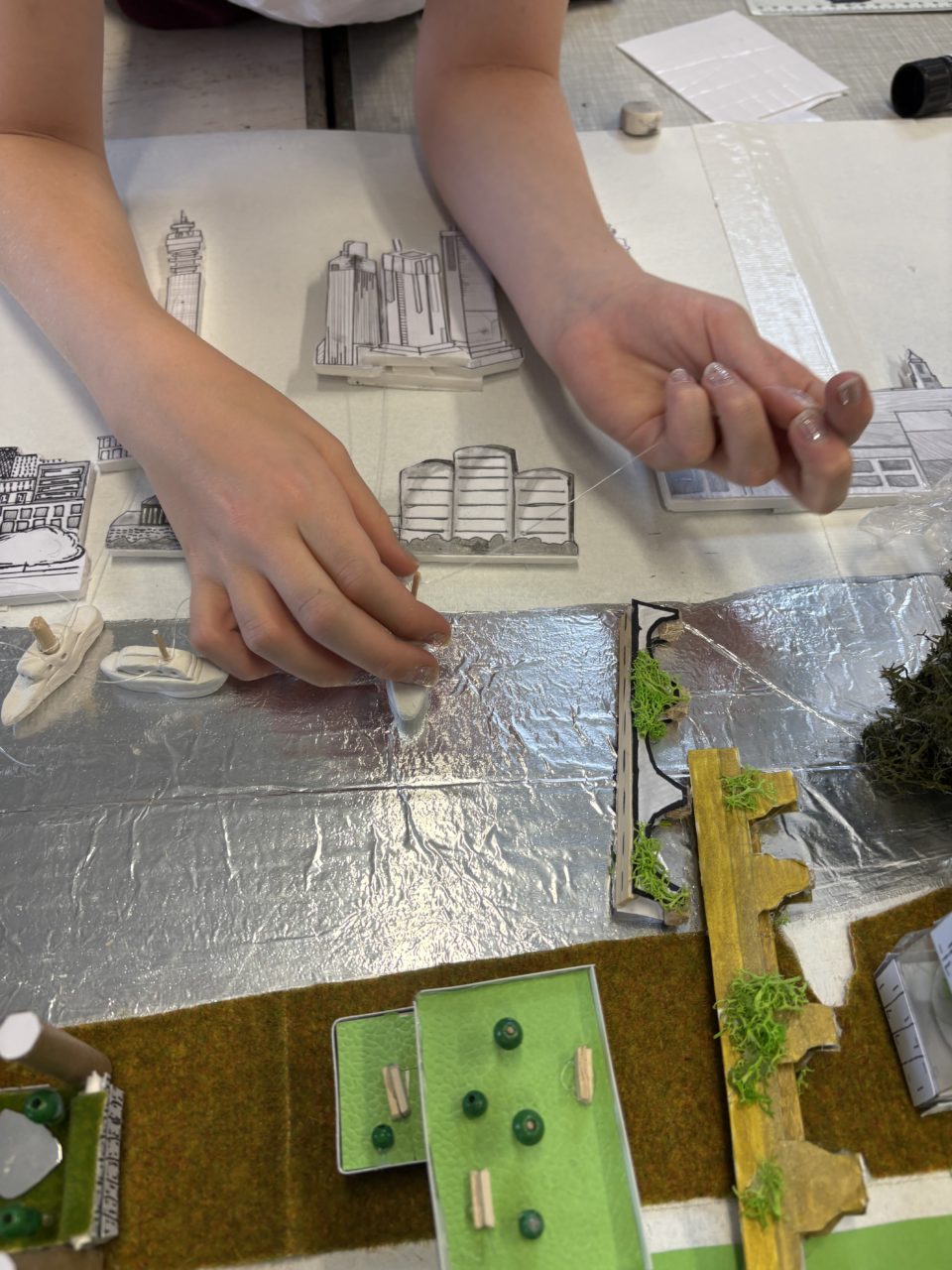 Children connected fishing wire to the north side buildings which were then raised by pulling the tug boats.
