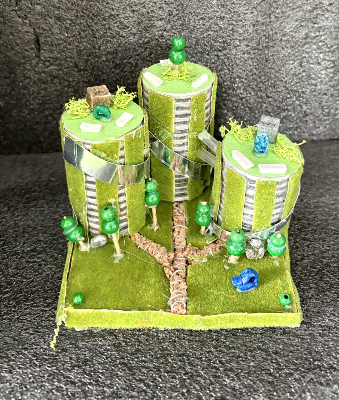 Year 6 pupils’ reimagined Tate Modern, transformed solar silver façades, vertical living walls and rooftop gardens. Elevated walkways connect the structures, while miniature trees, landscaped green spaces and pathways surround the buildings, sculptures are permanent features of the garden.